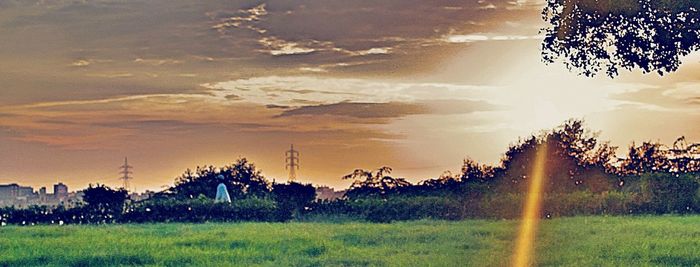 Scenic view of field against sky during sunset