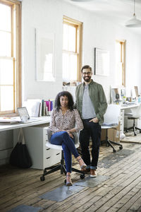 Portrait of smiling business people in creative office