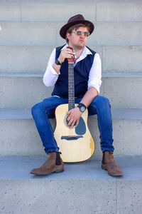 Portrait of young man playing guitar