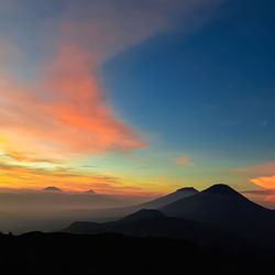 Scenic view of silhouette mountains against sky during sunset
