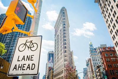 Low angle view of road sign against buildings