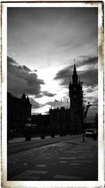 Buildings against cloudy sky