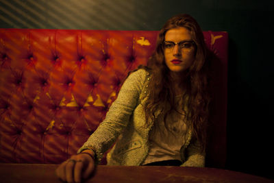 Portrait of young woman sitting outdoors
