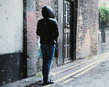 Full length of woman standing in front of building