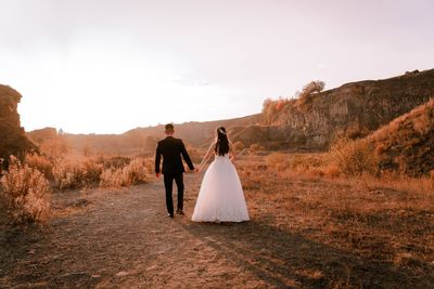 Rear view of couple walking outdoors