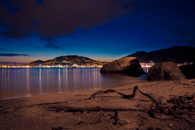 Scenic view of beach against sky at night