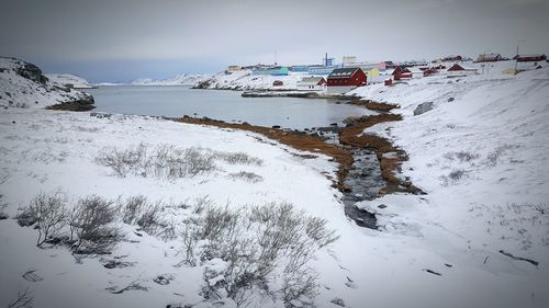 Panoramic view of people on beach against sky