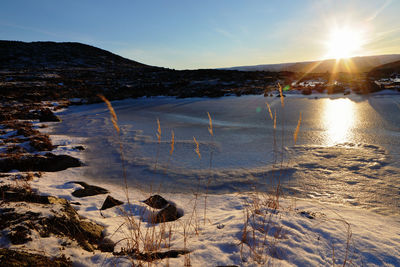 Scenic view of snow mountains against sky during sunset