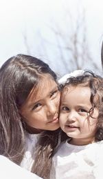 Portrait of happy mother and daughter against sky