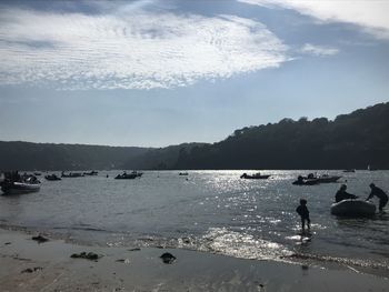 People on beach against sky