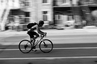 Man riding bicycle on road