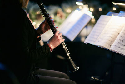 Midsection of man playing wind instrument