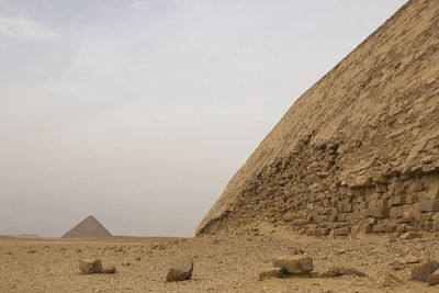 Stone wall in desert against sky