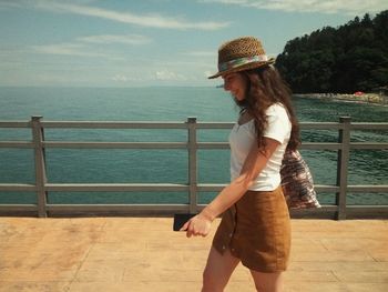 Woman walking on pier