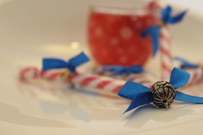 Close-up of blue christmas decoration and candy canes on table