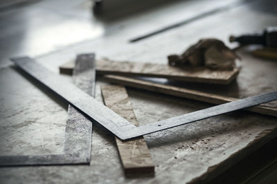 High angle view of metal and wood pieces at workshop