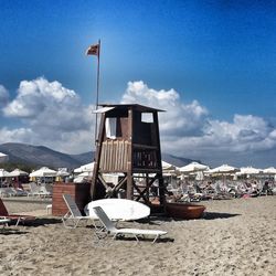 Lifeguard hut on beach against sky