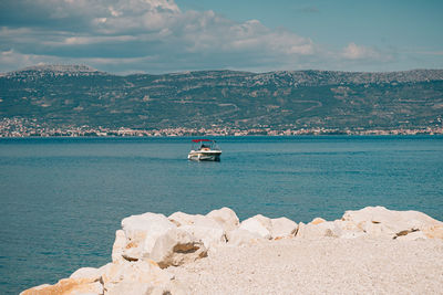 Sailboat sailing on sea against sky