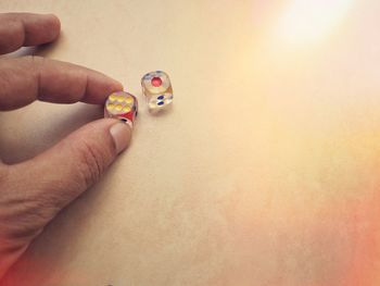 Close-up of woman hand holding multi colored ring