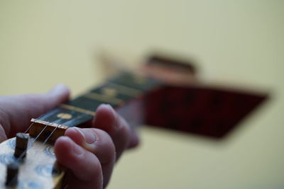 Close-up of person playing guitar