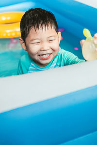 Portrait of cute baby boy in swimming pool