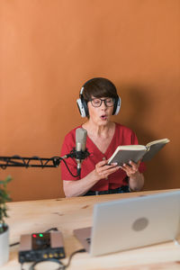 Woman podcasting at studio