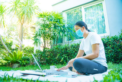 Full length of woman sitting outdoors