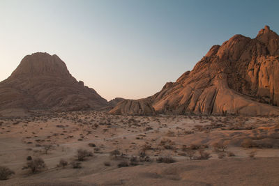 Scenic view of arid landscape against clear sky