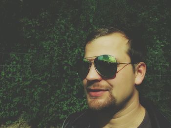 Close-up portrait of man wearing sunglasses