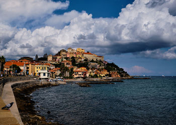 Town by sea against sky in city