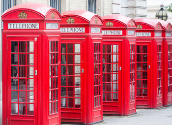 Red telephone booth in city