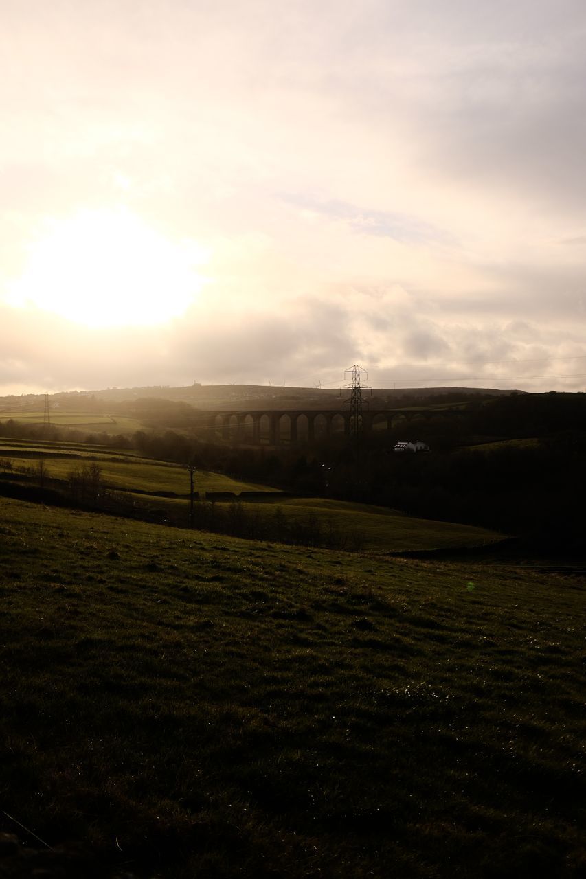 sky, morning, sunlight, horizon, environment, cloud, nature, landscape, dawn, tranquility, beauty in nature, scenics - nature, tranquil scene, field, no people, hill, light, land, sunrise, grass, sun, plant, outdoors, idyllic, non-urban scene, darkness, reflection, agriculture, tree, silhouette, architecture, rural scene