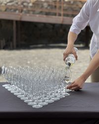 Midsection of man pouring wine