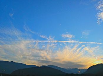Scenic view of mountains against cloudy sky