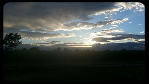 Scenic view of landscape against cloudy sky