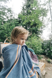 A portrait of a young girl in a towel after swimming in oregon.