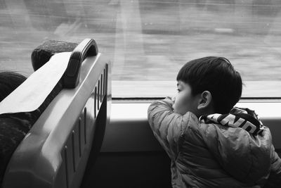 Young boy sitting on bus