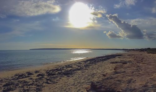 Scenic view of beach against sky during sunset