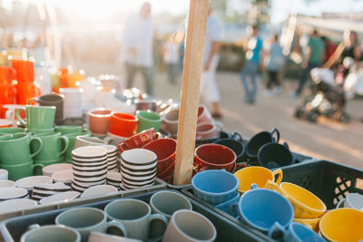 Various colorful cups at market for sale