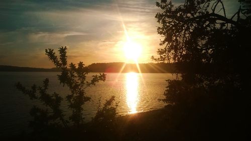 Scenic view of calm lake at sunset