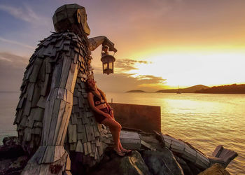Low angle view of statue against sky during sunset