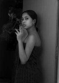 Portrait of beautiful woman standing at home