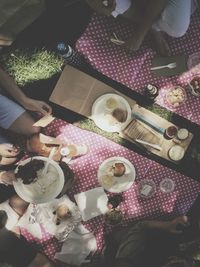 High angle view of people having snacks at picnic