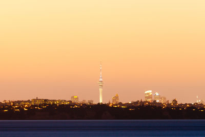 Illuminated buildings against sky during sunset
