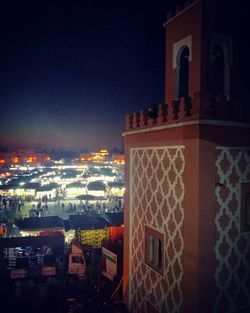 High angle view of illuminated buildings against sky at night