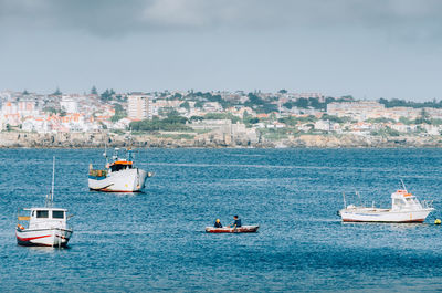 Sailboats sailing in sea against sky