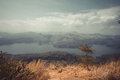 Scenic view of lake and mountains against sky