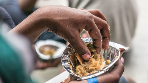 Close-up of man holding ice cream in bowl