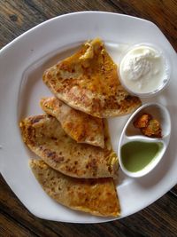 Directly above view of fresh paratha served in plate on table