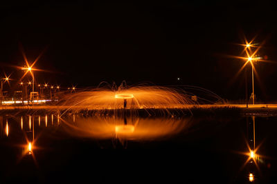 Illuminated light trails against sky at night